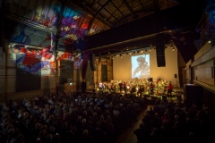 Photos and images adorn the screen and the ceiling